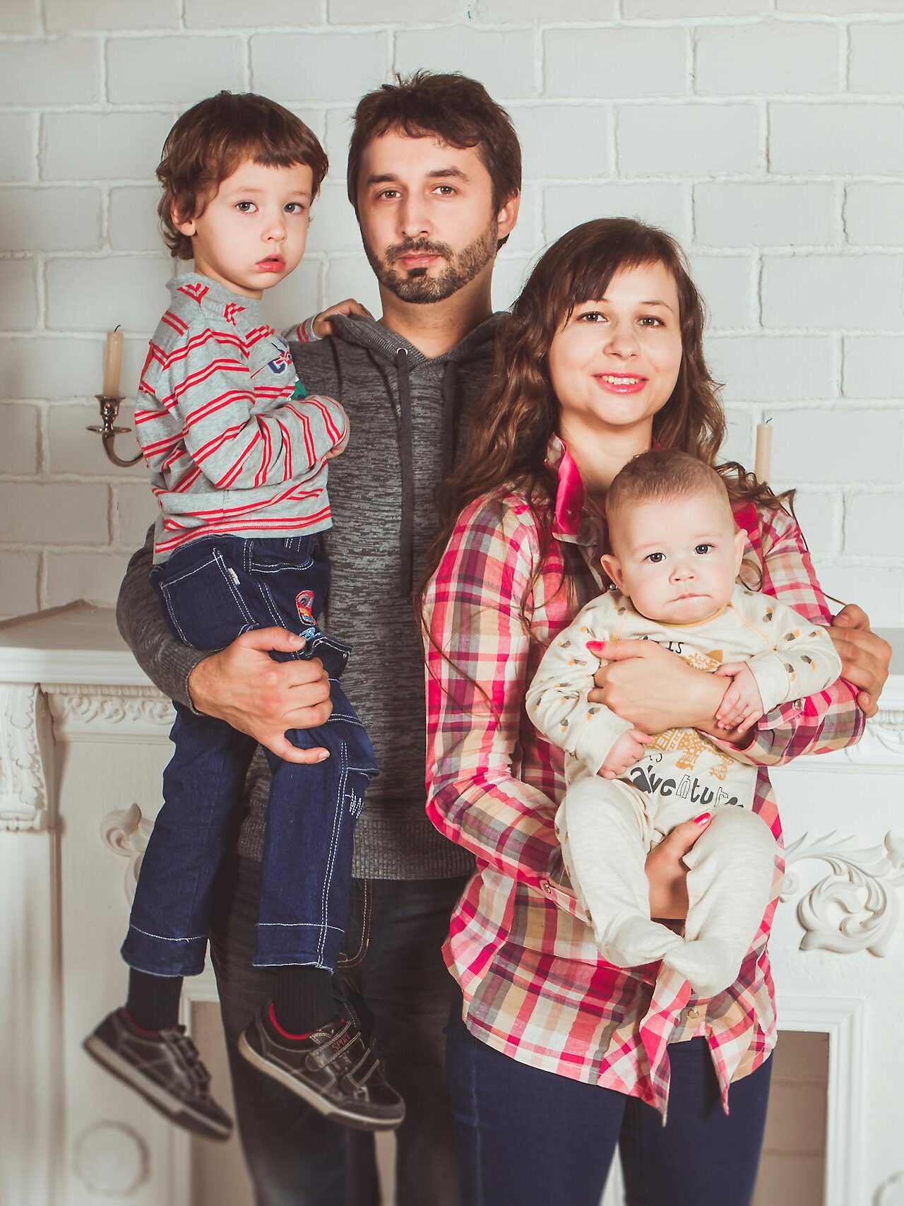 A joyful family posing together in a cozy living room, embodying love and togetherness.
